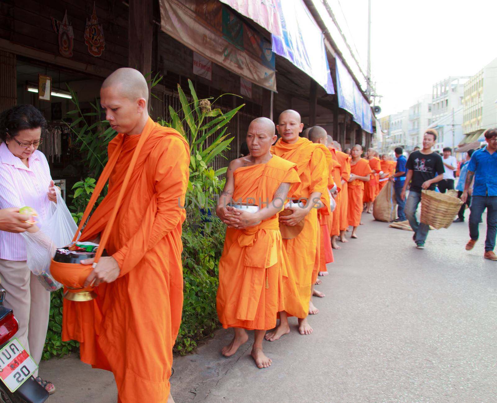 Phrae,Thailand - October 31,2012 : Unidentified Buddhist monks is given food offering from people at the morning on End of Buddhist Lent Day. on october 31, 2011 in Muang, Phrae, Thailand.