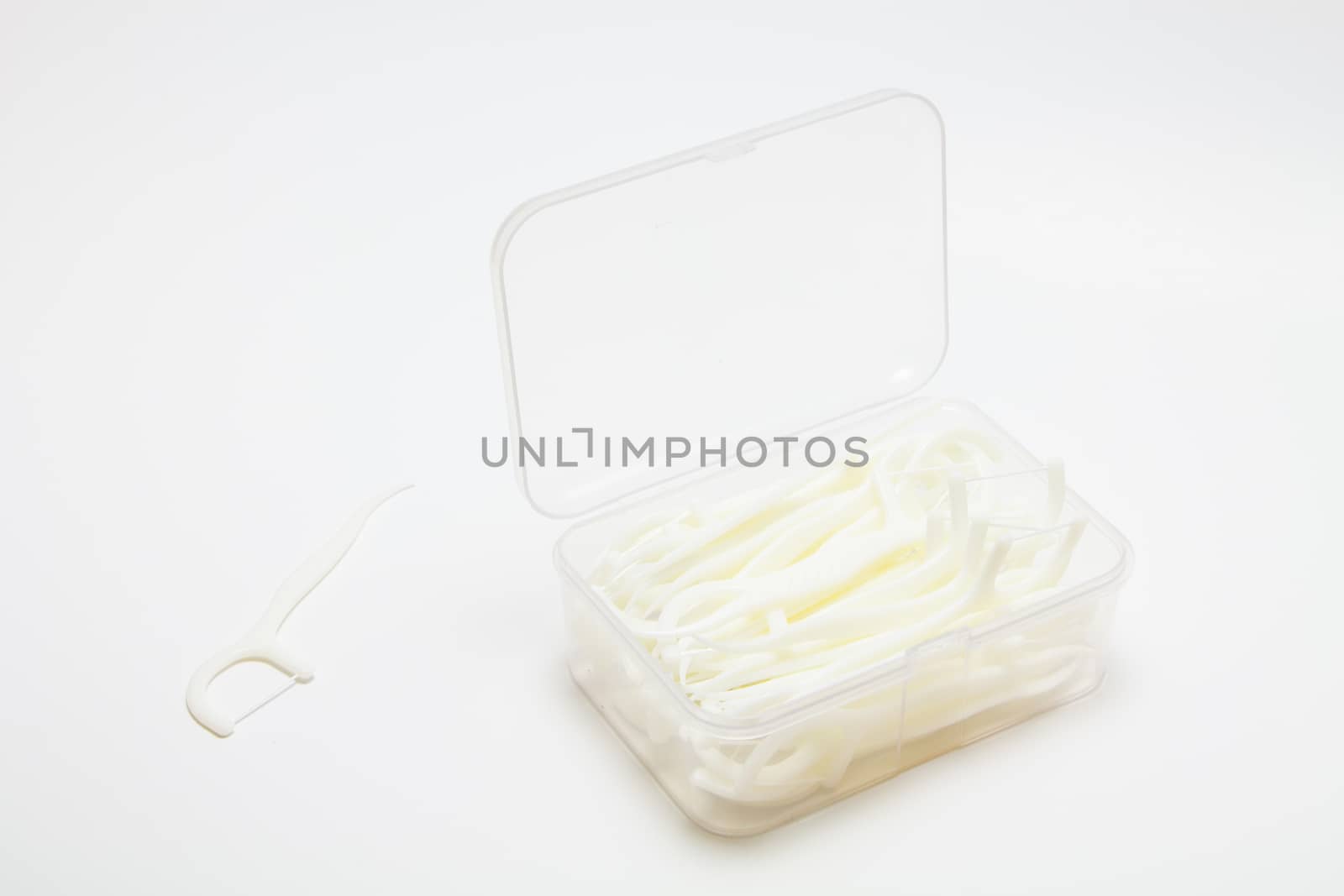 Dental flossers Toothpick with dental floss on white