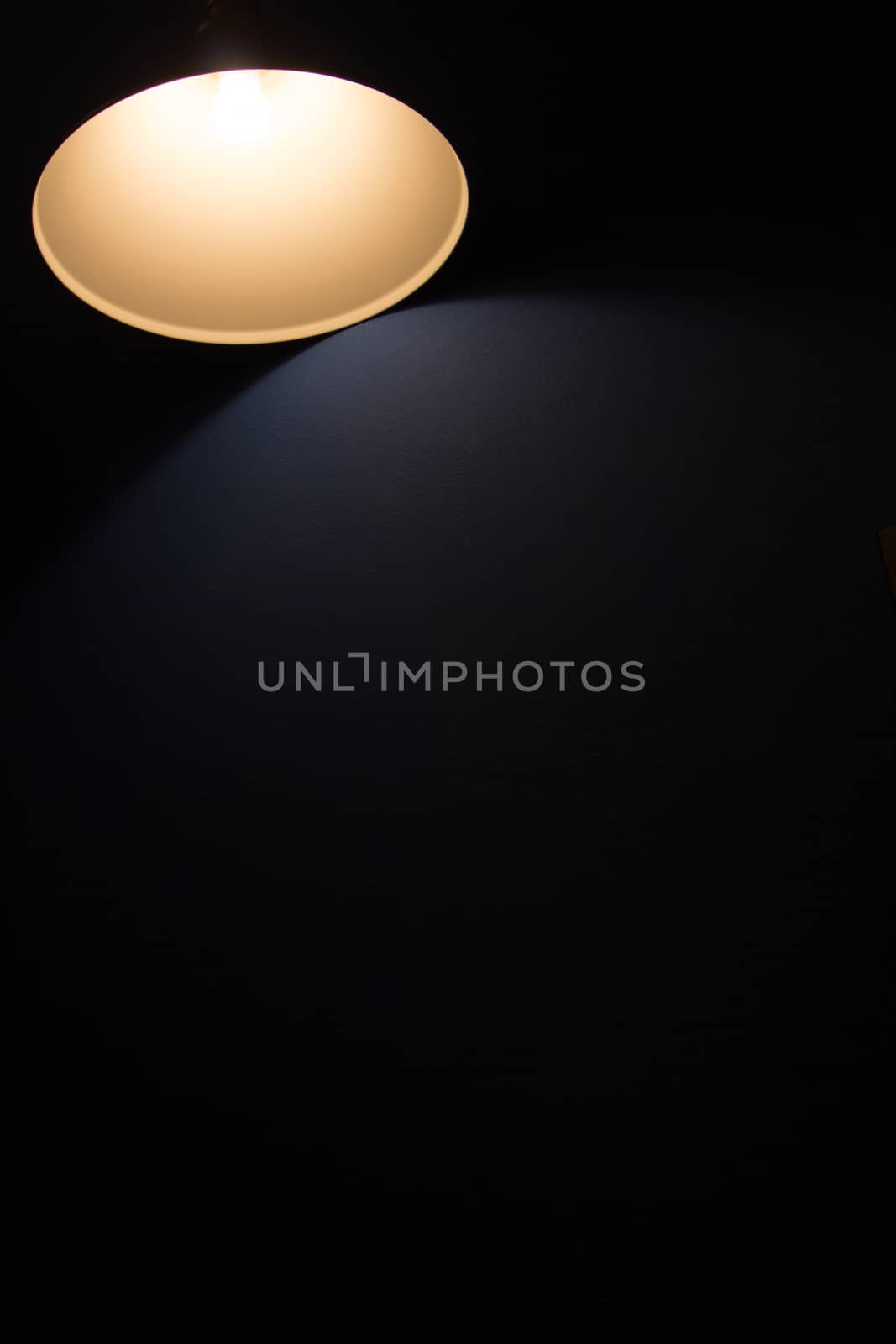 A glowing lamp in a dark room