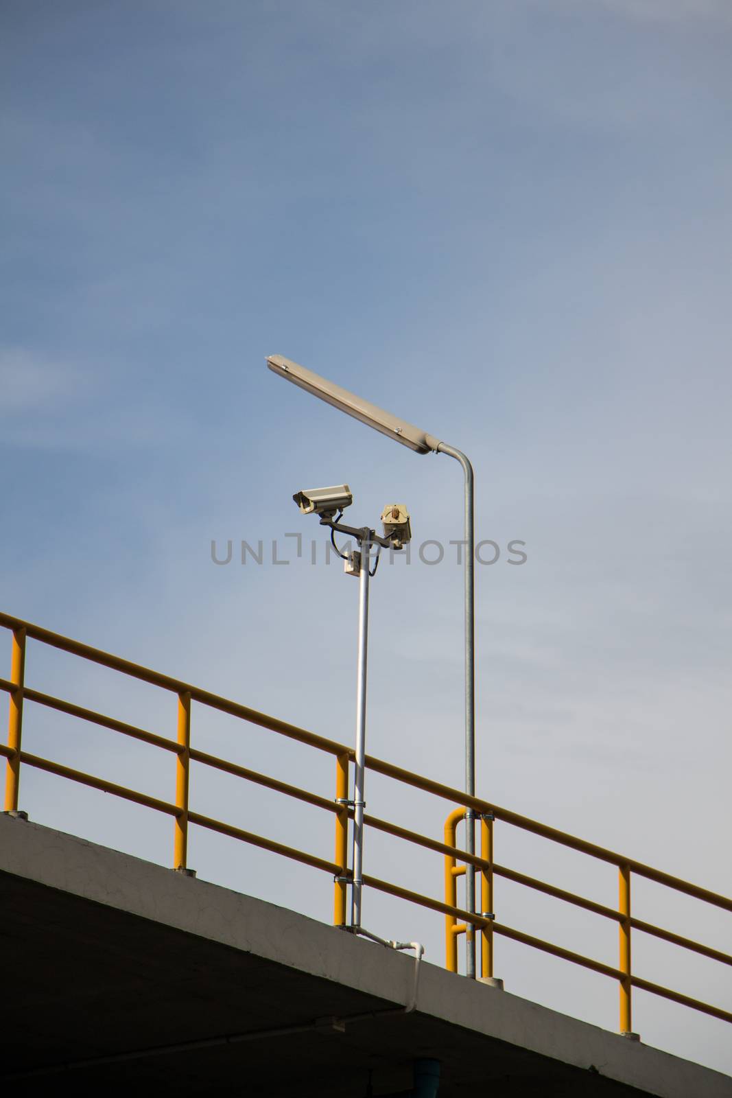 CCTV security cams at carpark and blue sky.