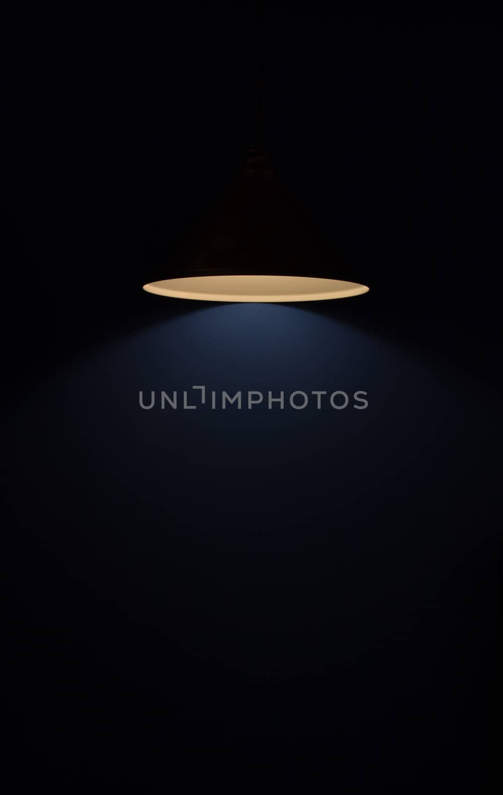 A glowing lamp in a dark room