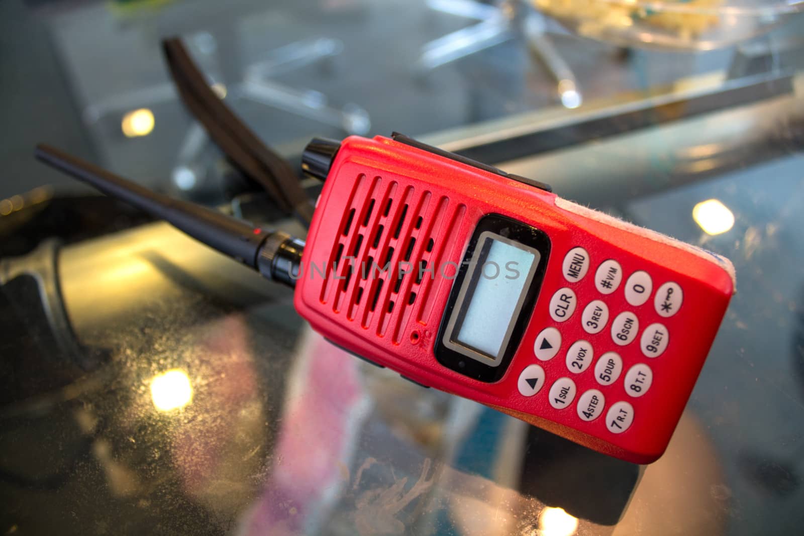 Handheld Tranceiver Red Color on the table.