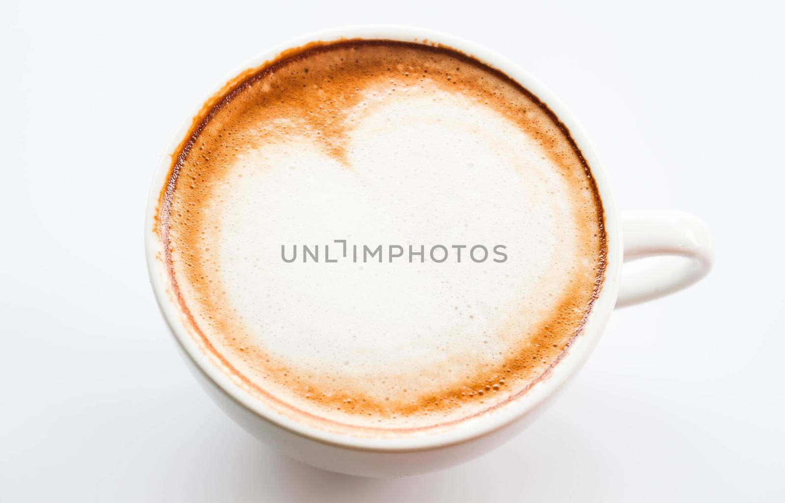 Cup of hot coffee latte with microfoam on top by punsayaporn