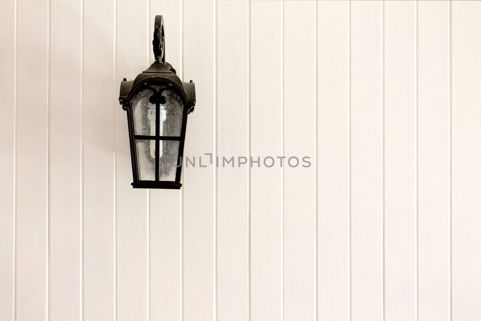 Black Lampposts on a white wall background.