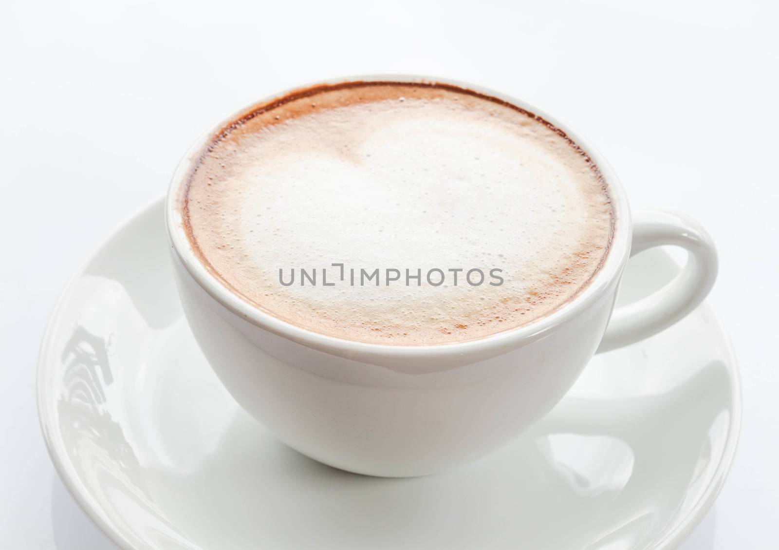 Heart shape of milk microfoam on coffee latte