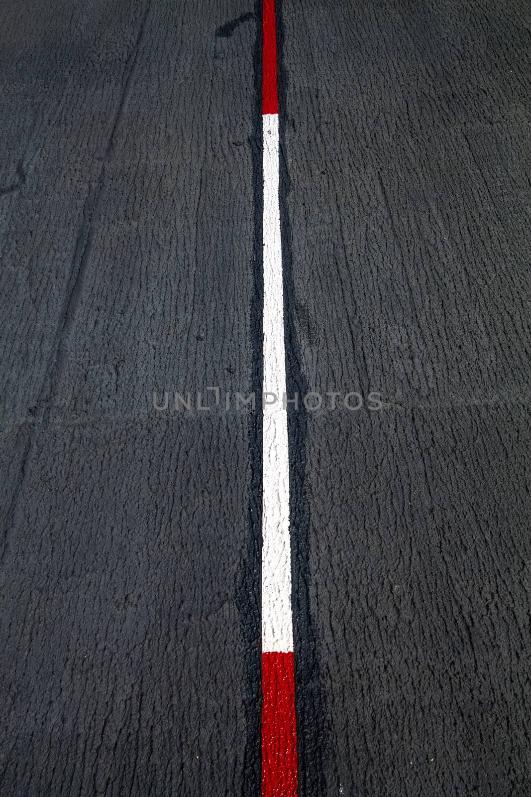 Red and white traffic lines on Asphalt road.