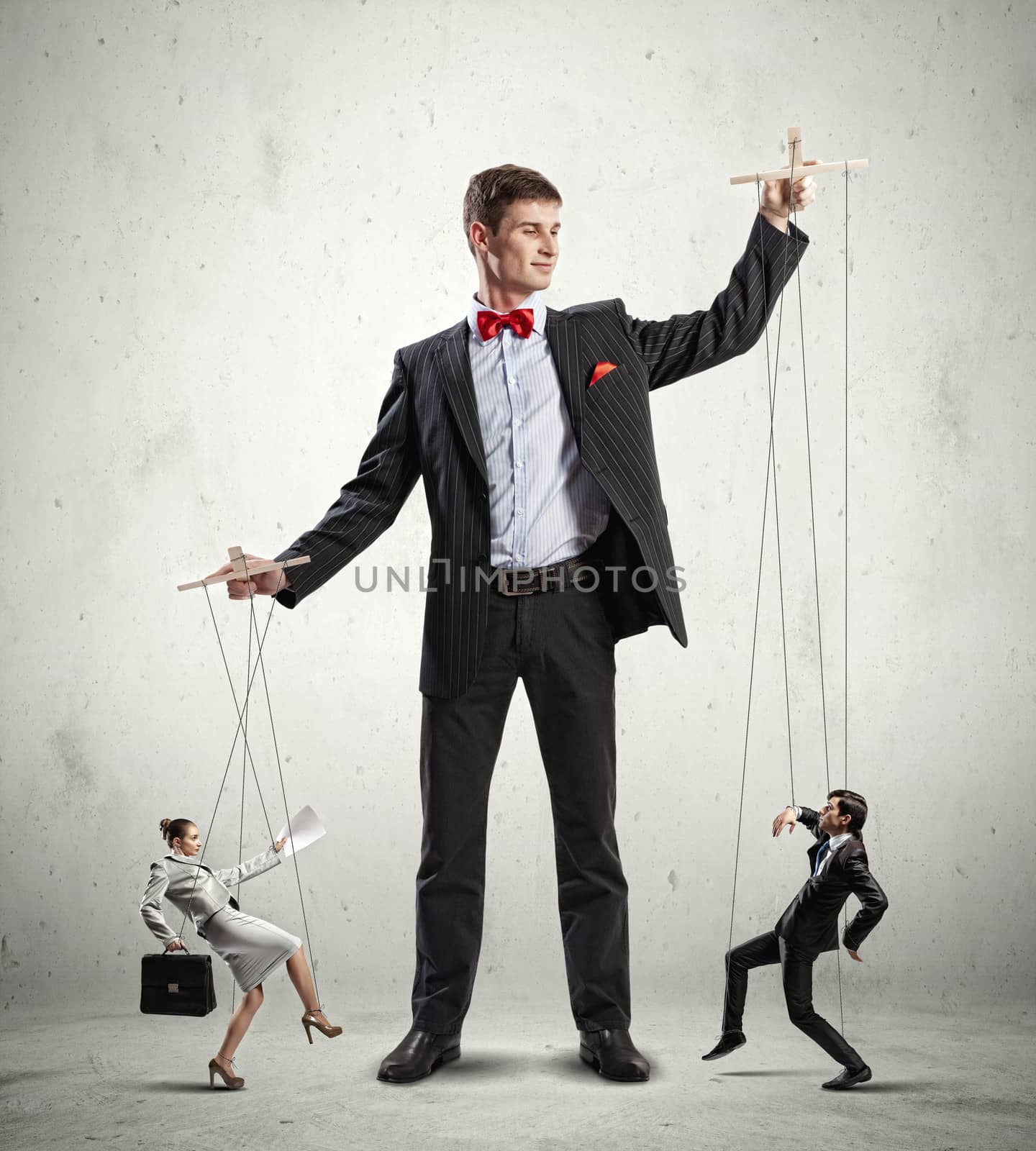 Image of young businessman puppeteer. Leadership concept