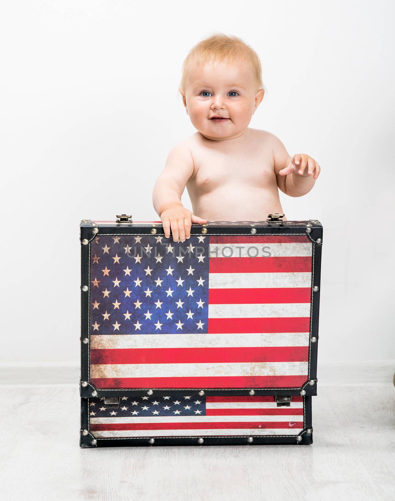 baby with a suitcase in colors of American flag