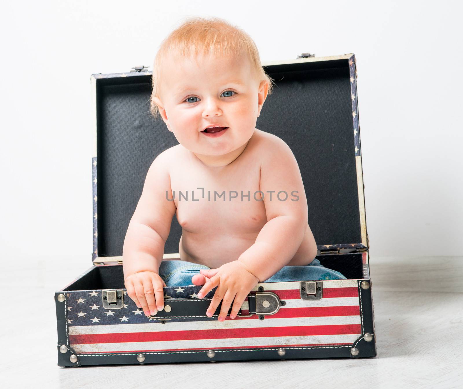 cute baby in a suitcase with American flag