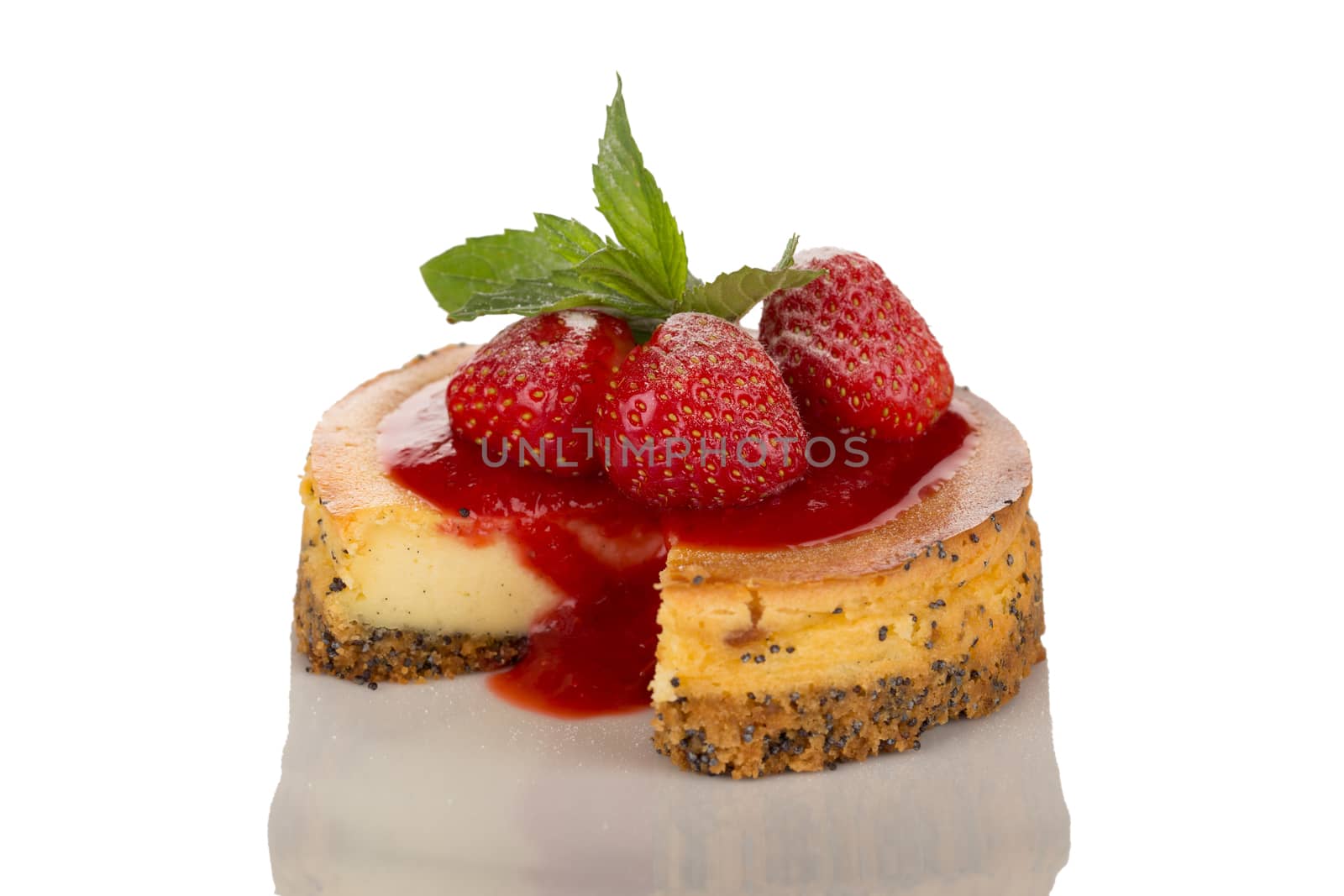 Cheesecake with strawberries, red coulis and mint isolated on white background.