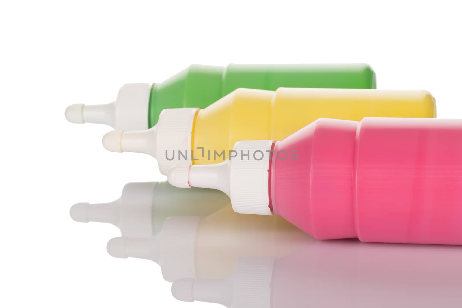 Bottles of paint isolated on white background close up.