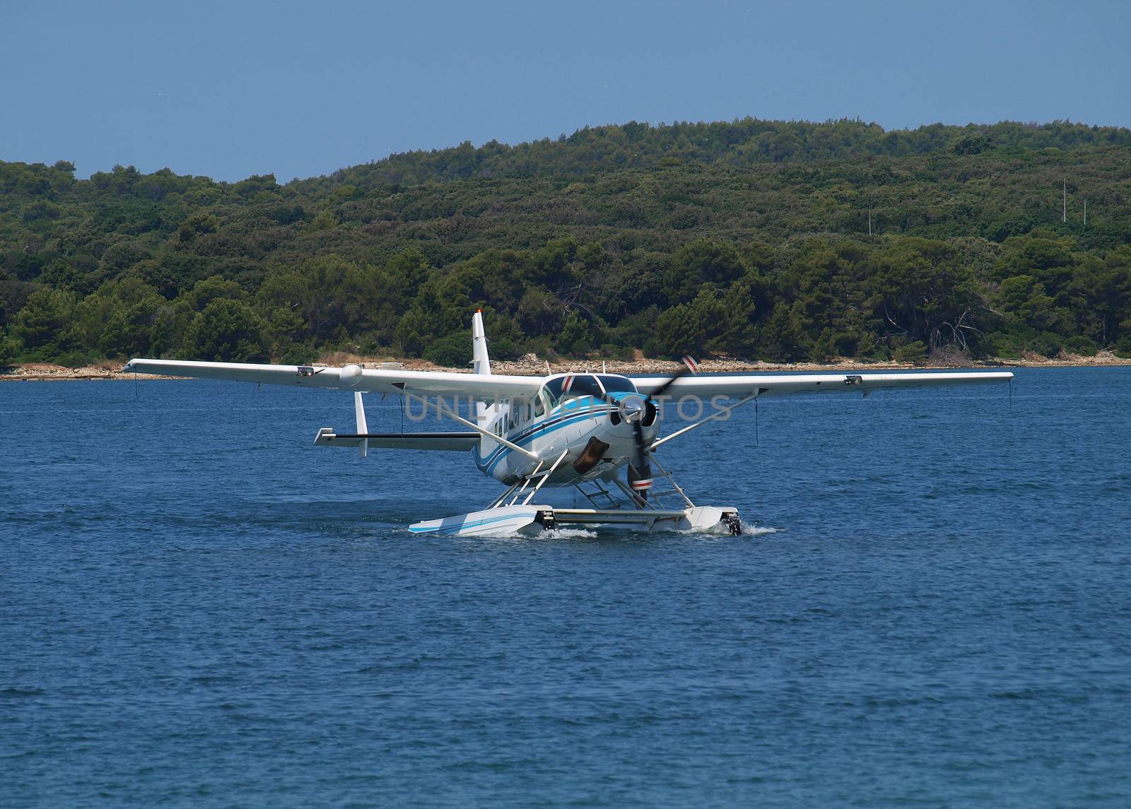 sea plane landing on water surface      