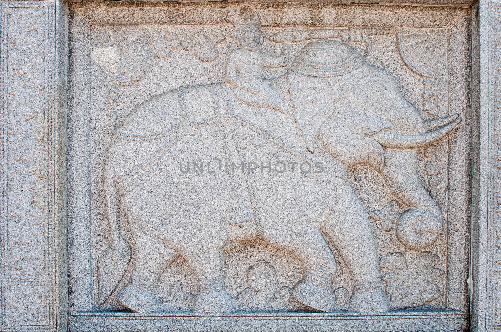 Stone carving with man riding elephant on a wall Duddhist  Temple of the Sacred Tooth Relic in Kandy, Sri Lanka 