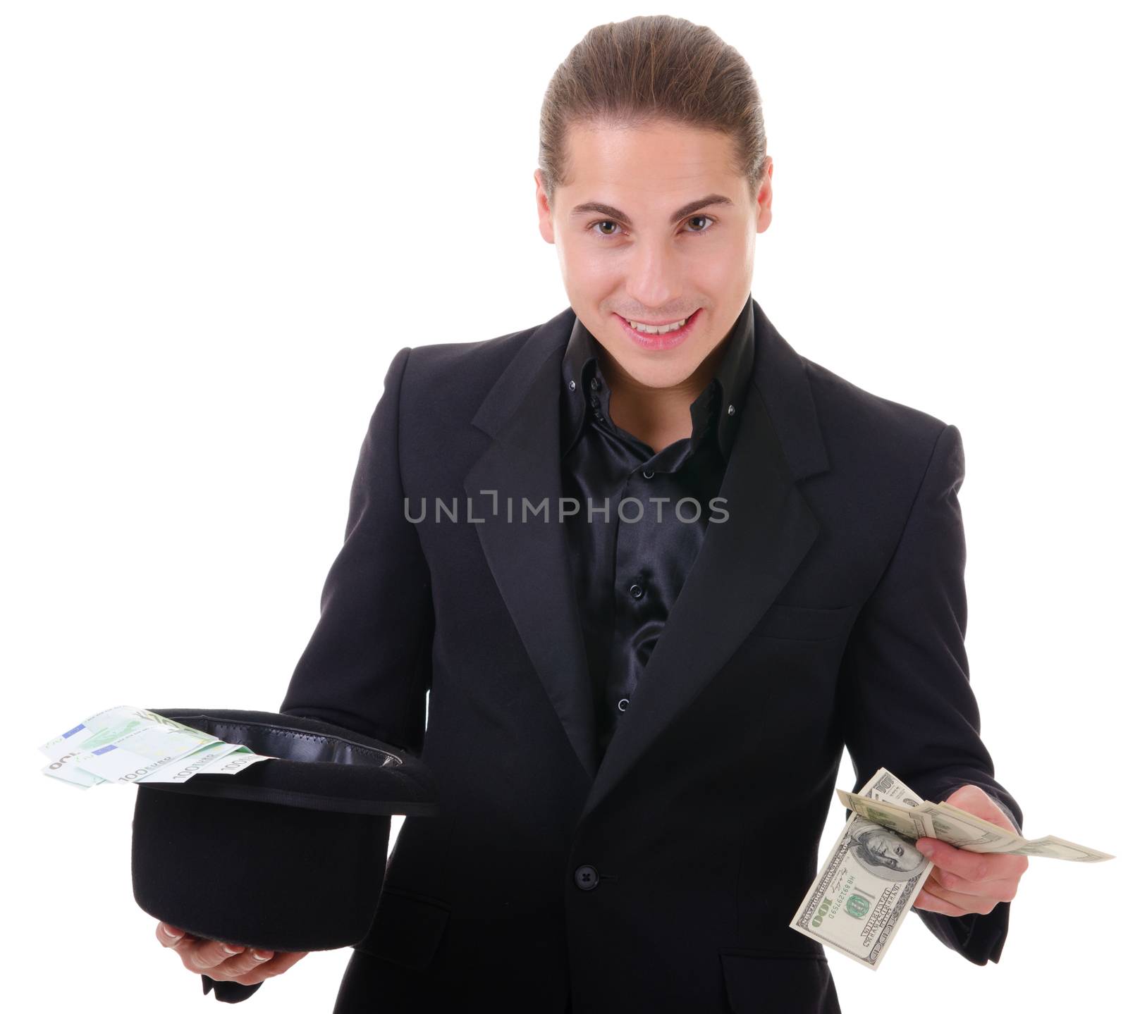 Paper money cash in dollars and euro from a hat holded by man in black suit. Isolated on white.