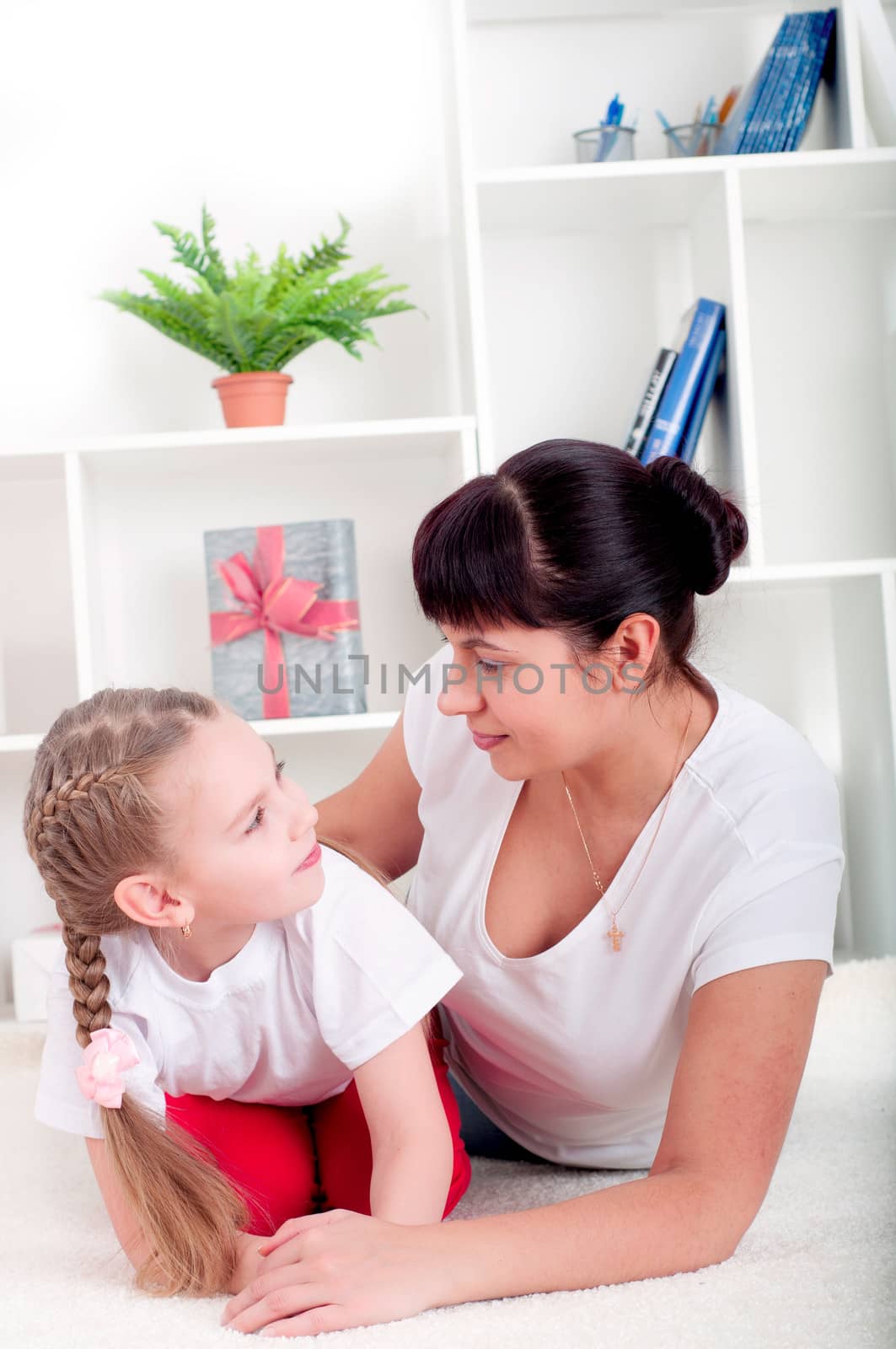 Portrait of happy family lying together, hugging and happy