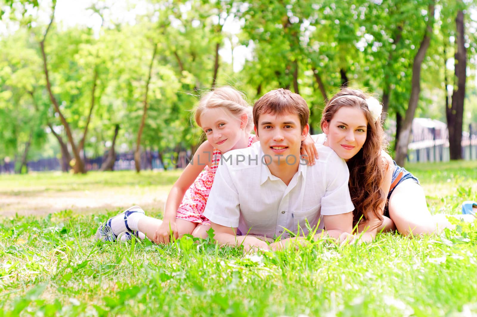 Family lying in the park by adam121