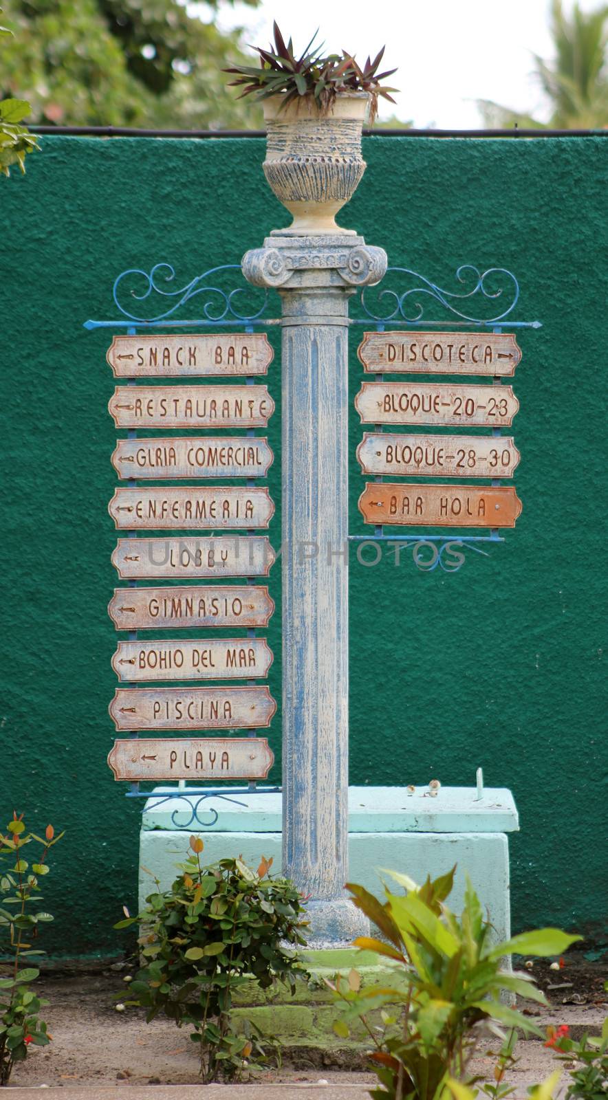 A Spanish sign post at a Cuban resort, pointing the way to various areas