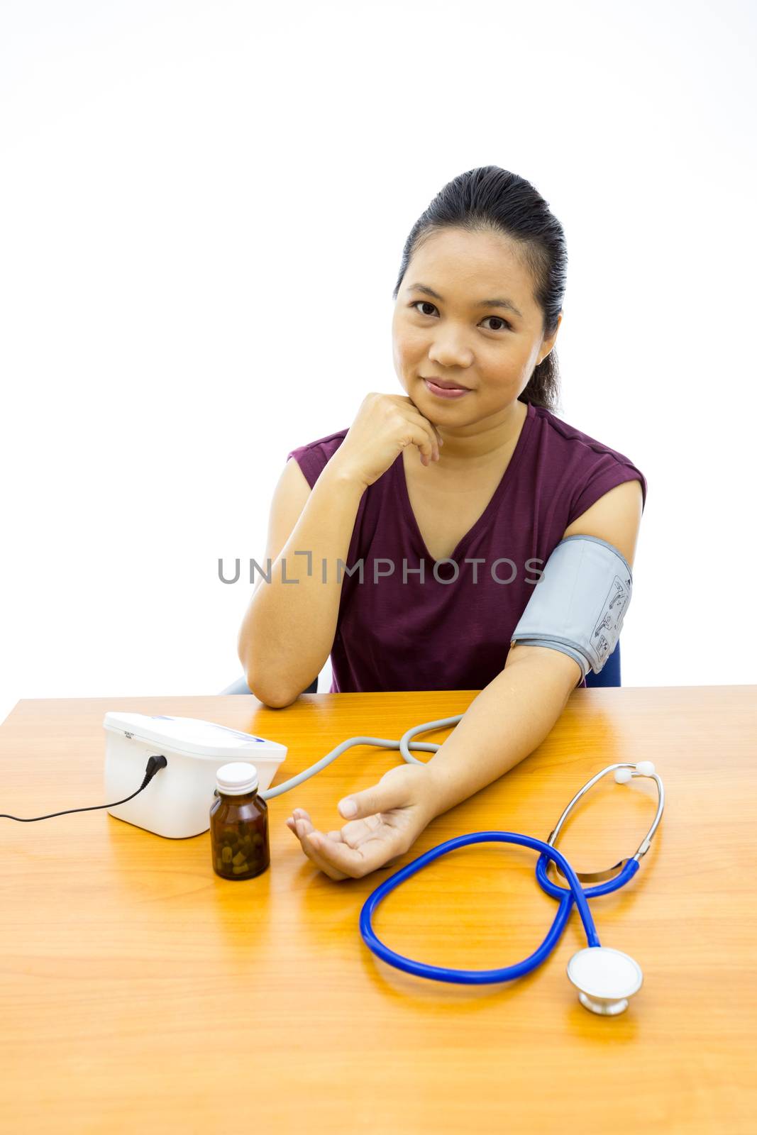 woman happy with her self blood pressure test by vichie81