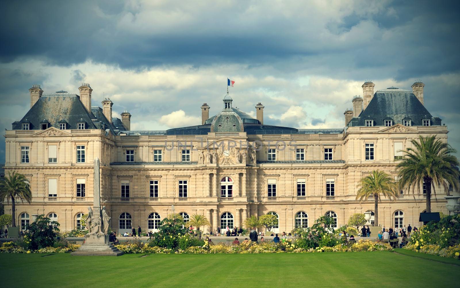 People enjoy autumn sunny day in the Luxembourg Garden on October 2, 2012 in Paris. Luxembourg Palace is the official residence of the President of the French Senate.