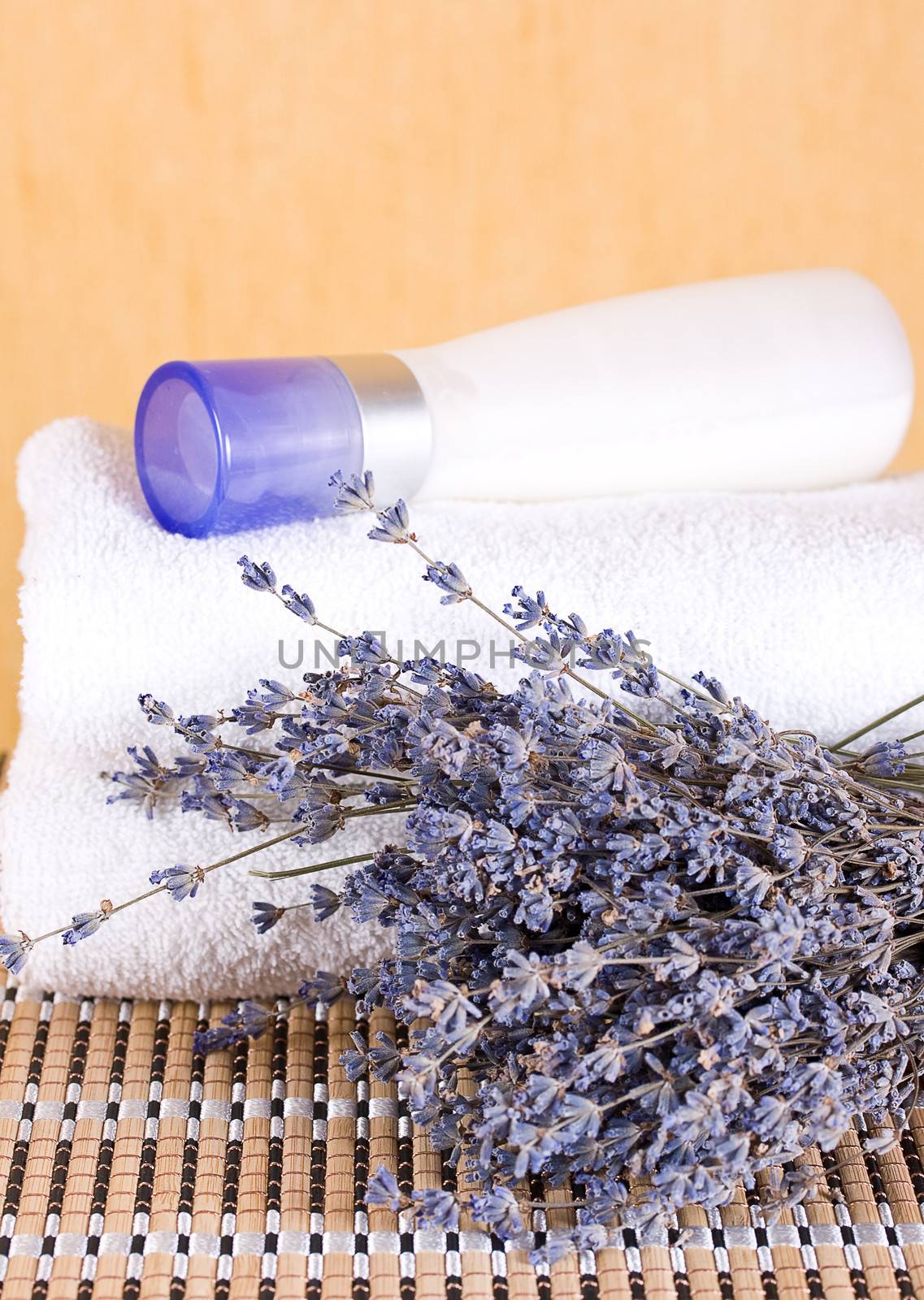 Cream with extracts of lavender and lavender flowers with a towel