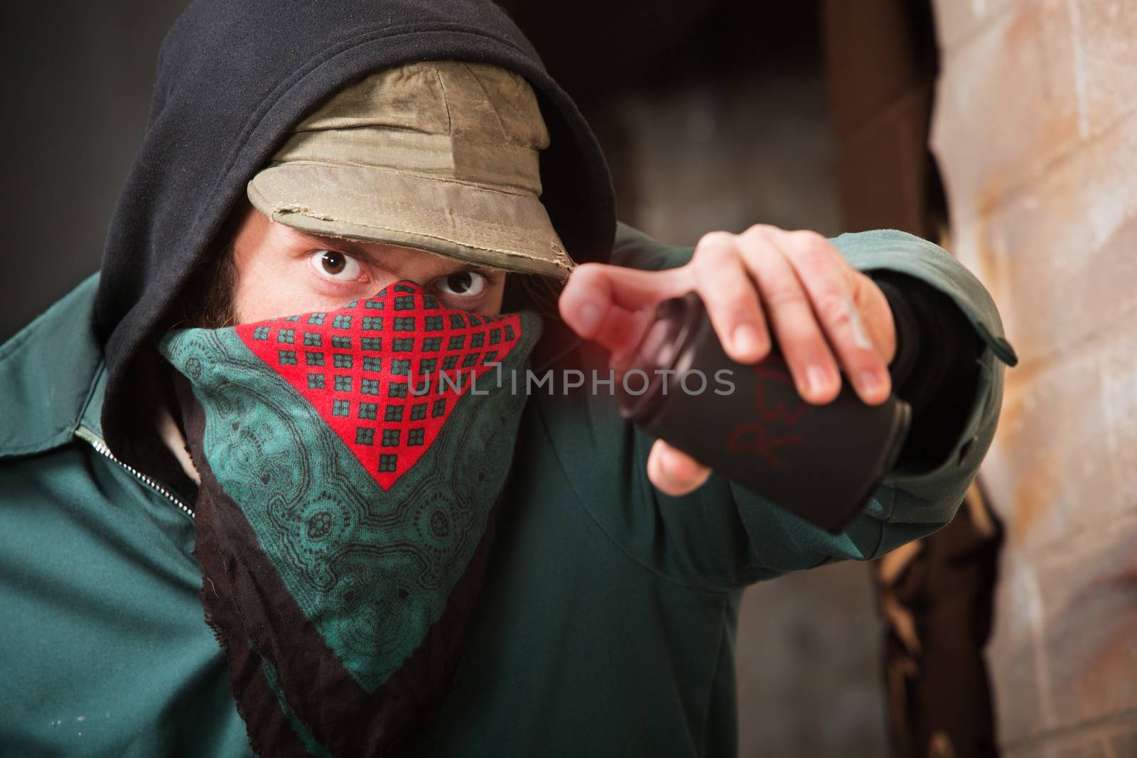 Tough gang member with spray paint can