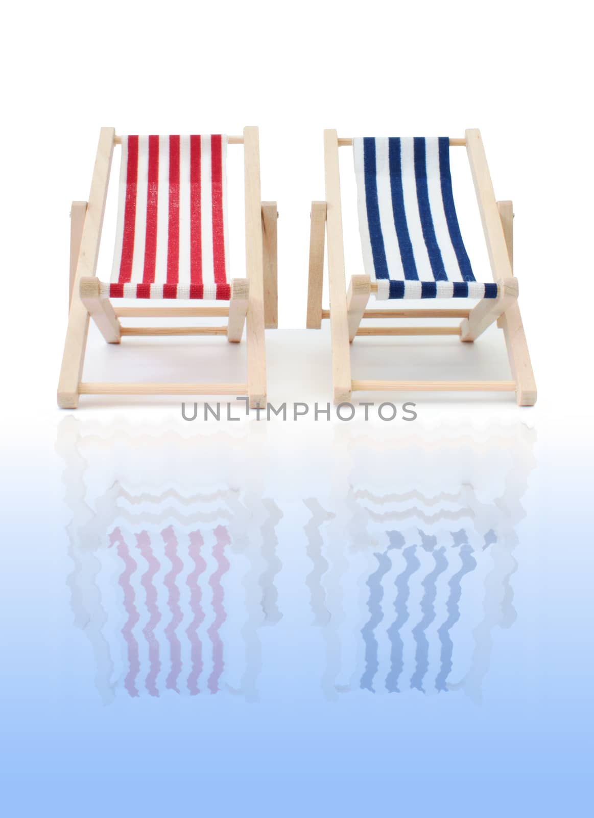 Red and blue deckchair reflecting in water 