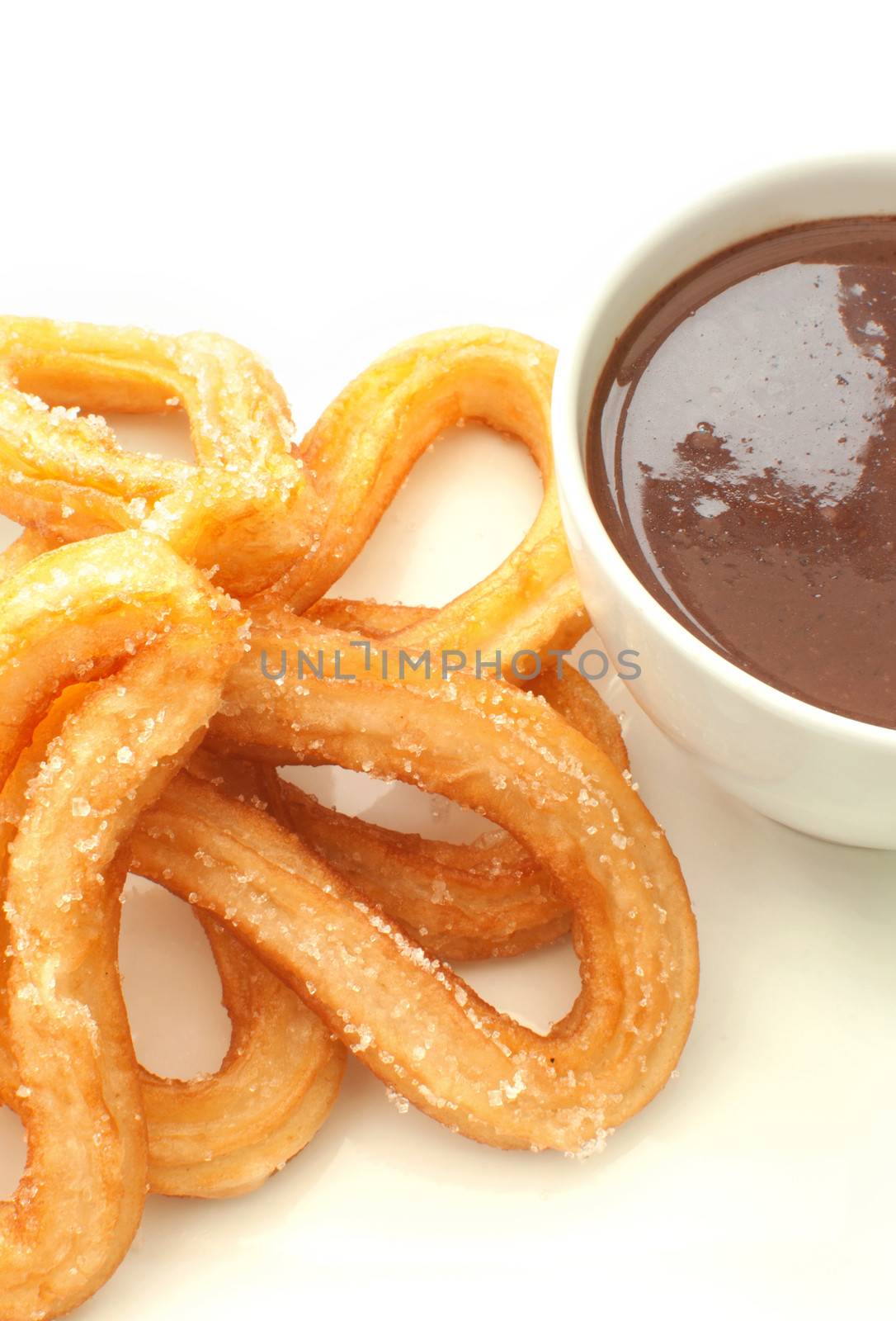 Traditional spanish churros donuts with thick hot chocolate in a cup