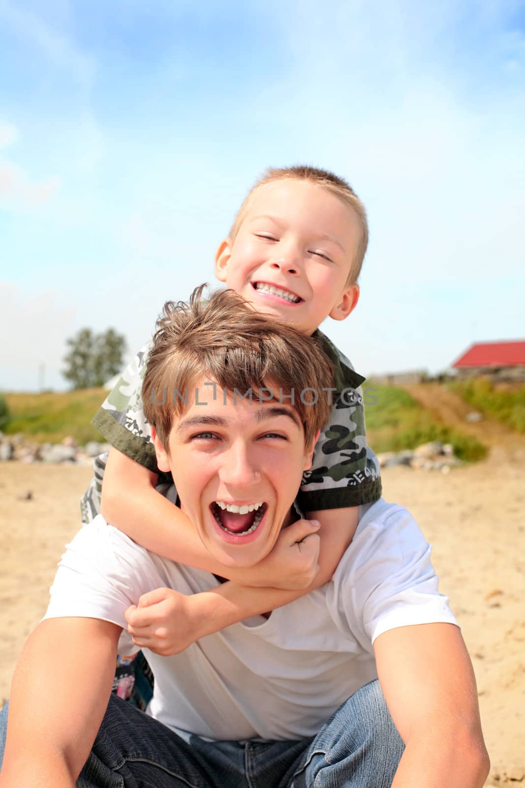 happy teenager and kid on the beach