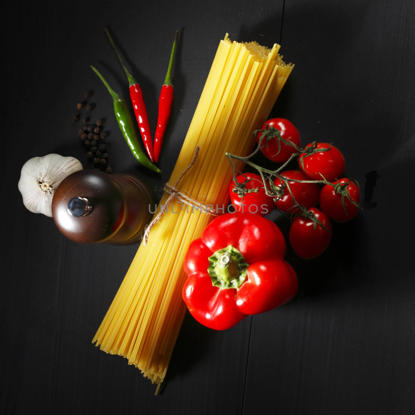 Pasta ingredients on black table by Yellowj