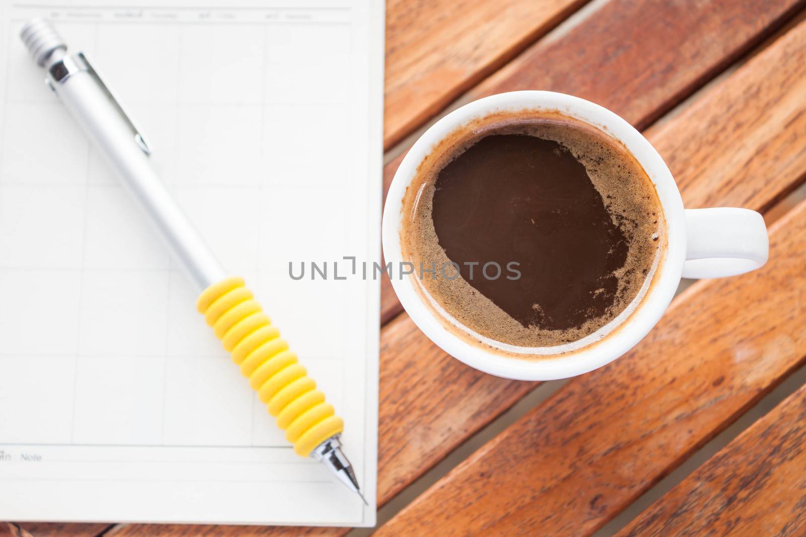 Cup of hot espresso on work wood table