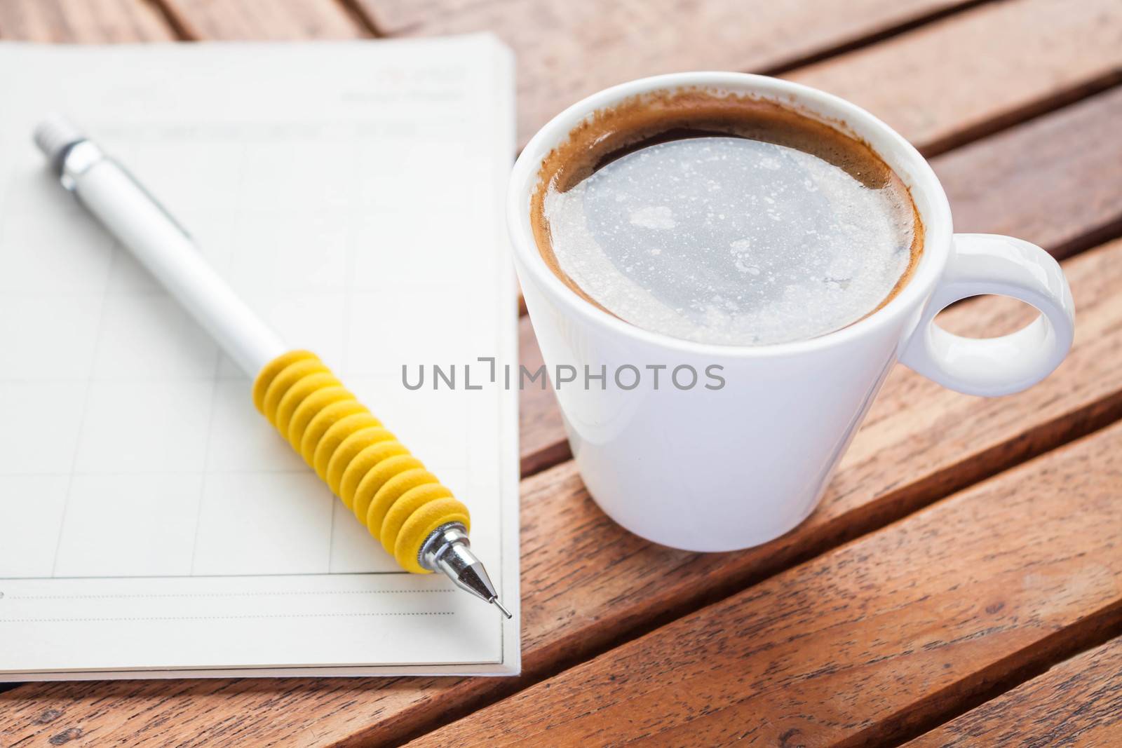 Coffee break with hot espresso on work wood table