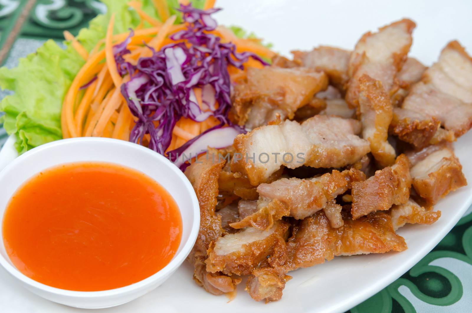 close up  chili sauce  and  fried pork  served with fresh  vegetable 