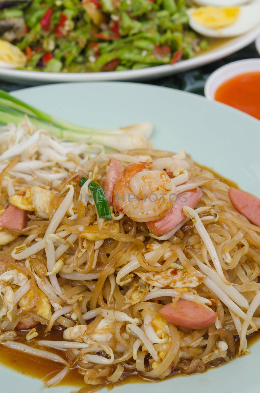 close up stir fried  noodles with shrimp , egg, sausage  and  vegetable