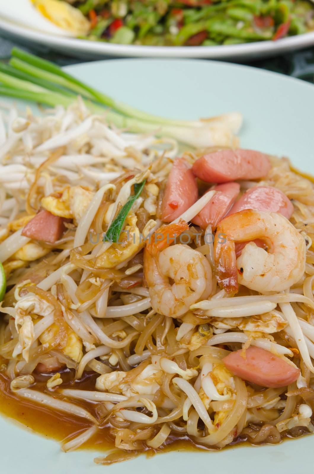 Stir fried  noodles with shrimp ,sausage ,  egg  and fresh vegetable , asian style food