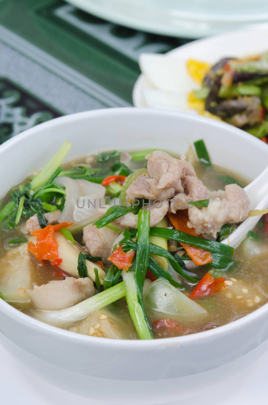 close up spicy pork soup in white bowl , asian soup