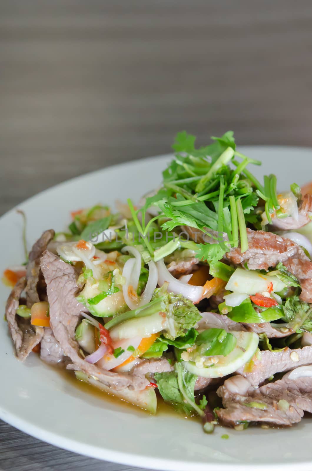 grilled beef with mix vegetable and chili sauce, spicy salad on dish