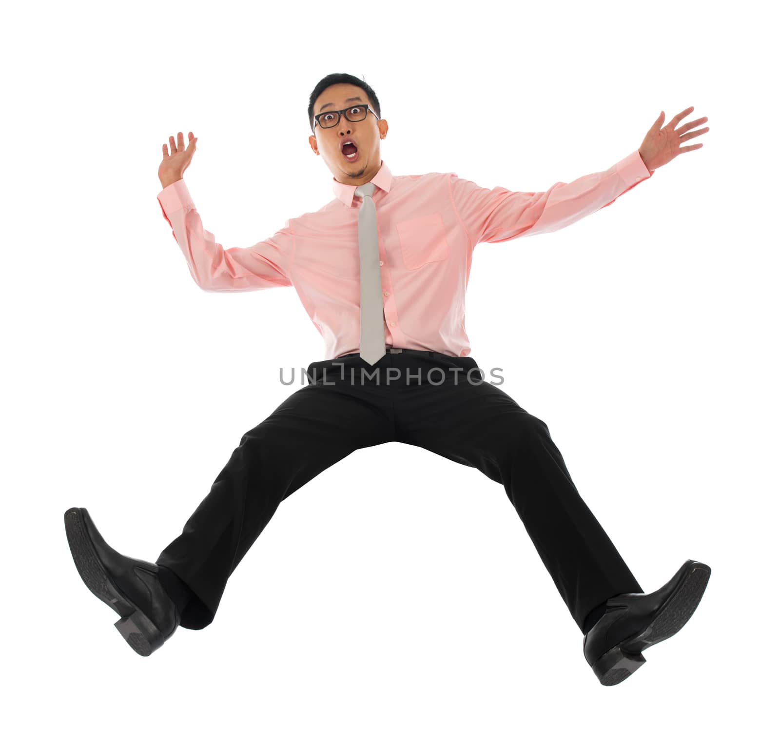 Full body shocked young Asian businessman falling backwards open arms, isolated on white background