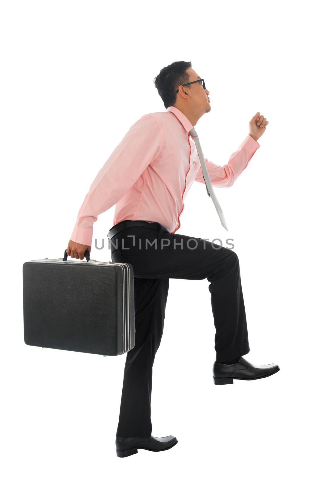 Full body young Asian businessman climbing virtual ladder with briefcase, isolated on white background