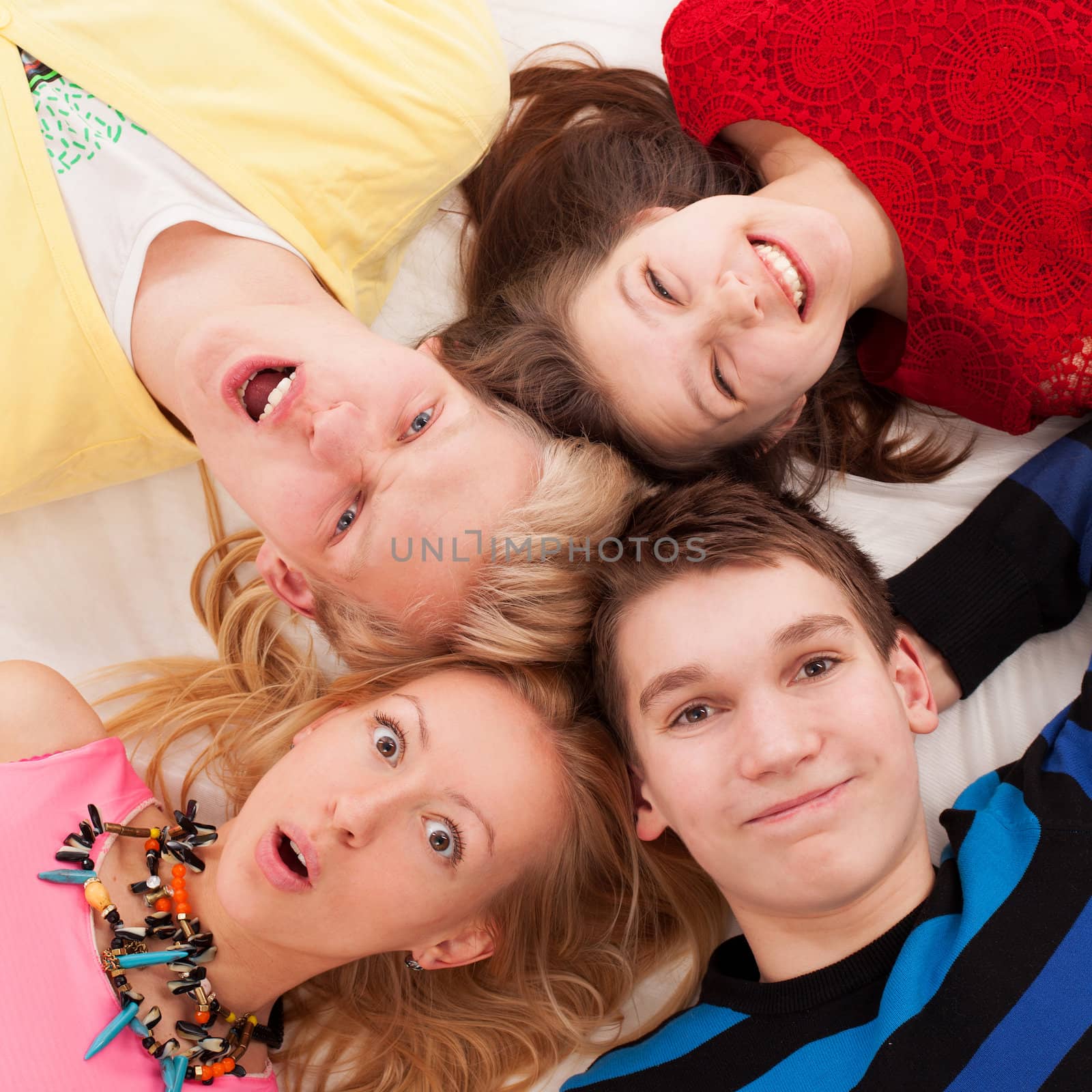 Brothers and sisters lying on a floor together