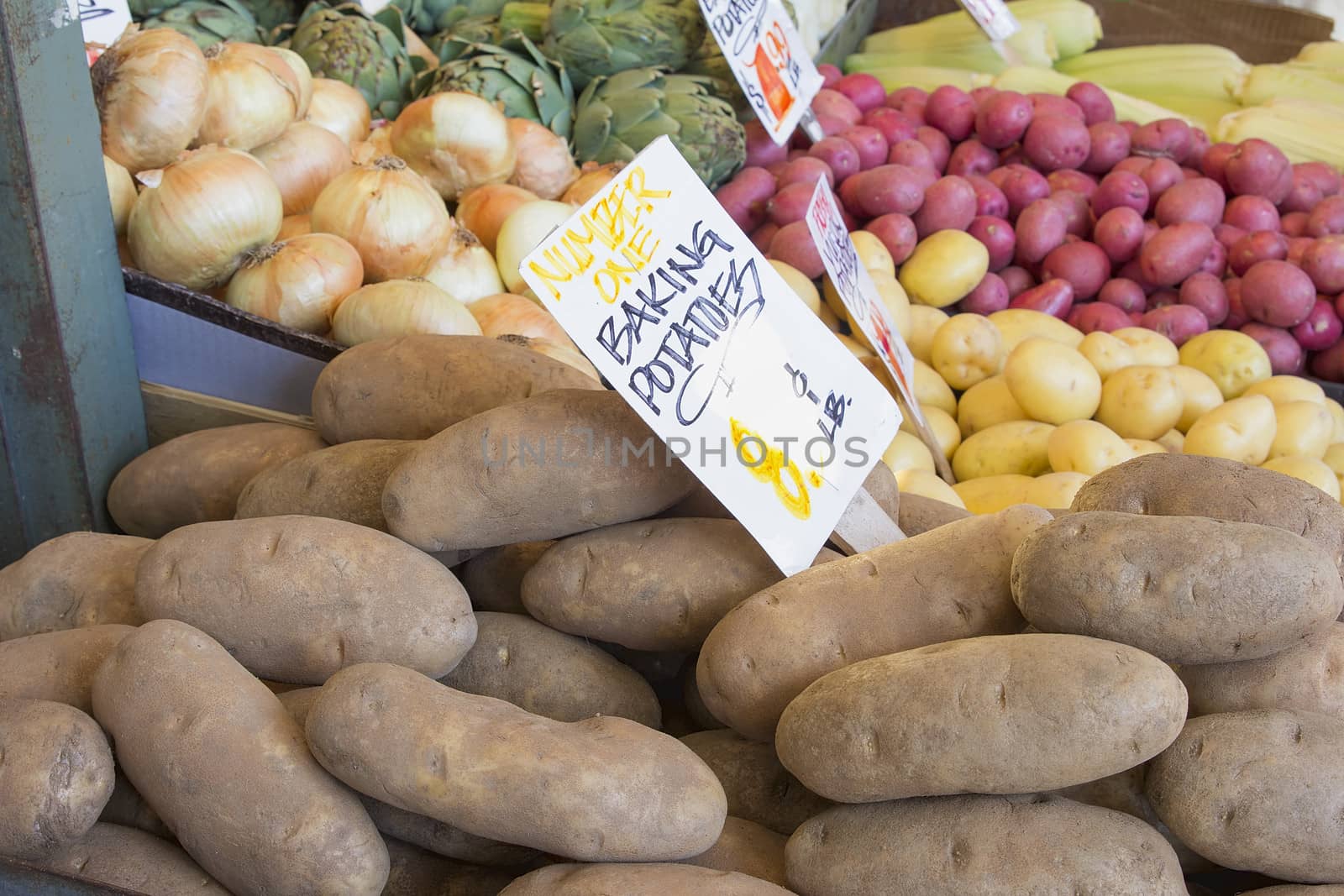 Baking Potatoes Onions Artichokes Vegetables Stall Display with Signs at Farmers Market
