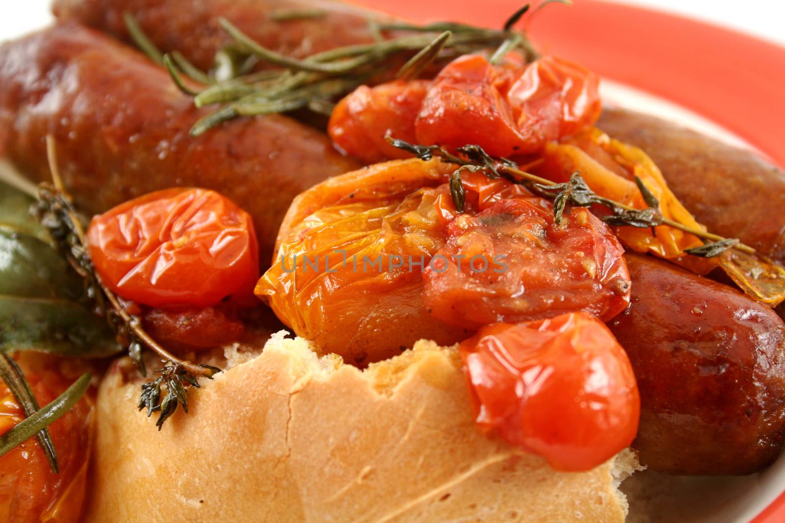 Delicious beef sausage and cherry tomato bake with rosemary.