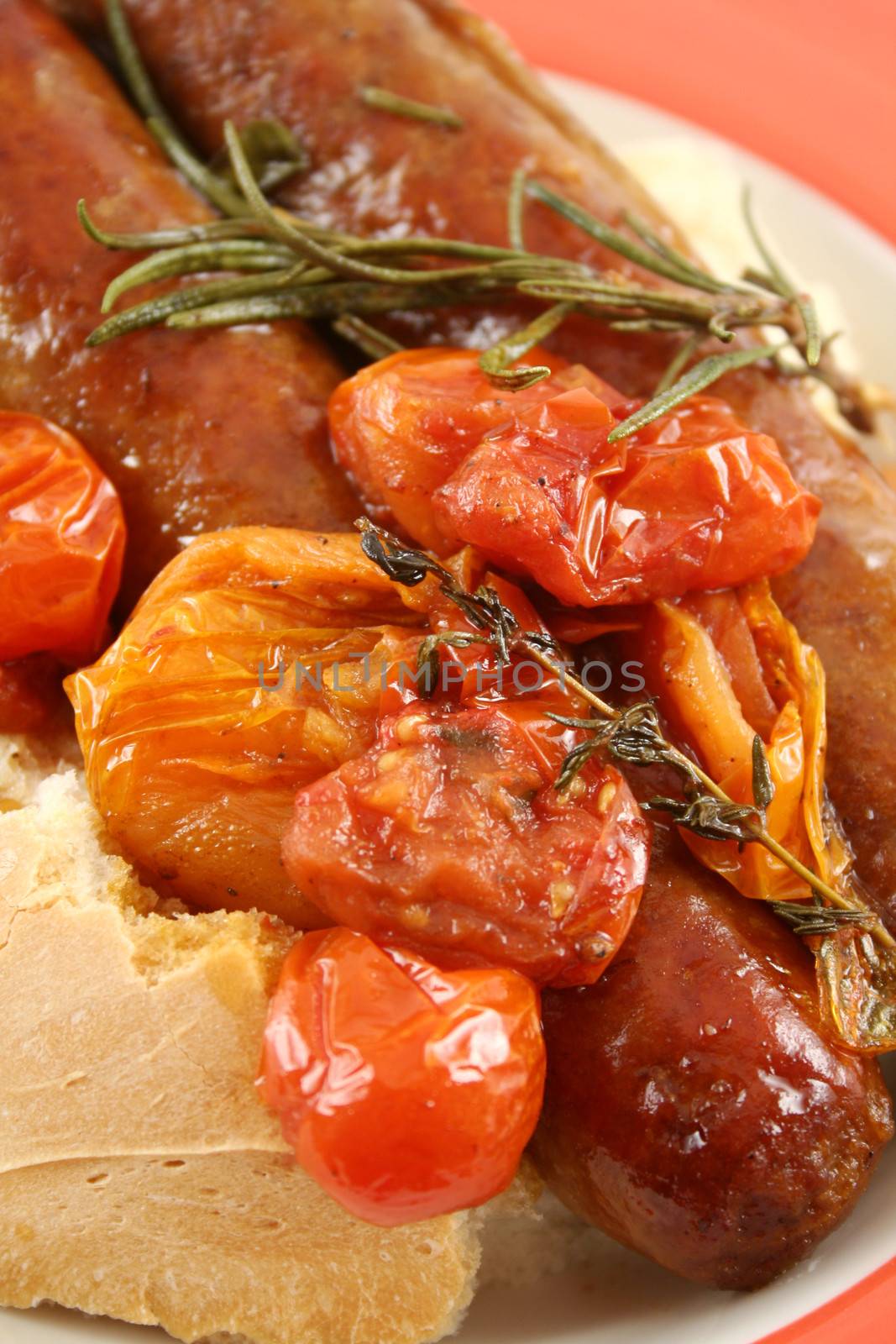 Delicious beef sausage and cherry tomato bake with rosemary.