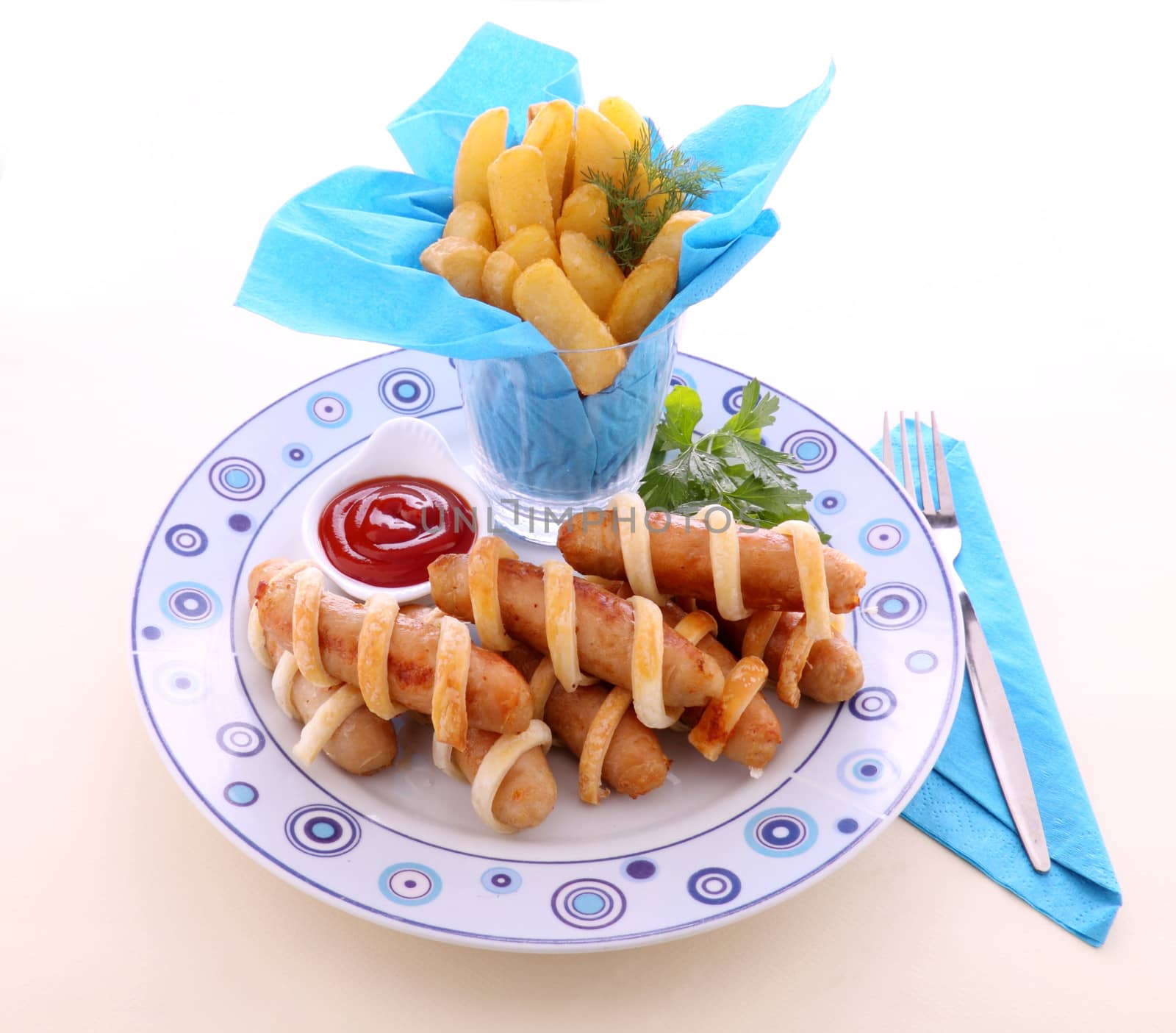 Twisted pastry around chicken sausages with fries and ketchup.