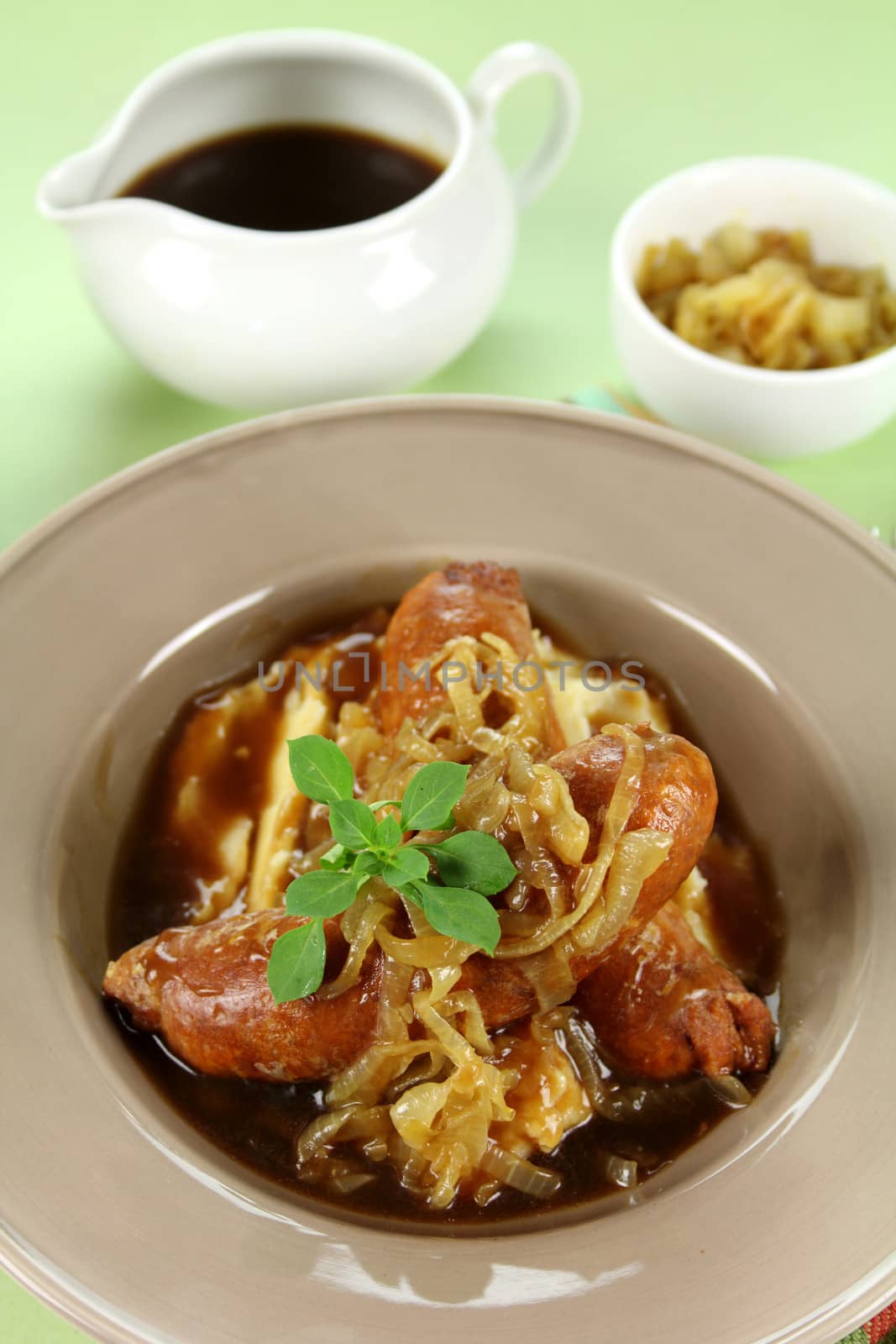 The classic English meal of bangers and mash with gravy ready to serve.