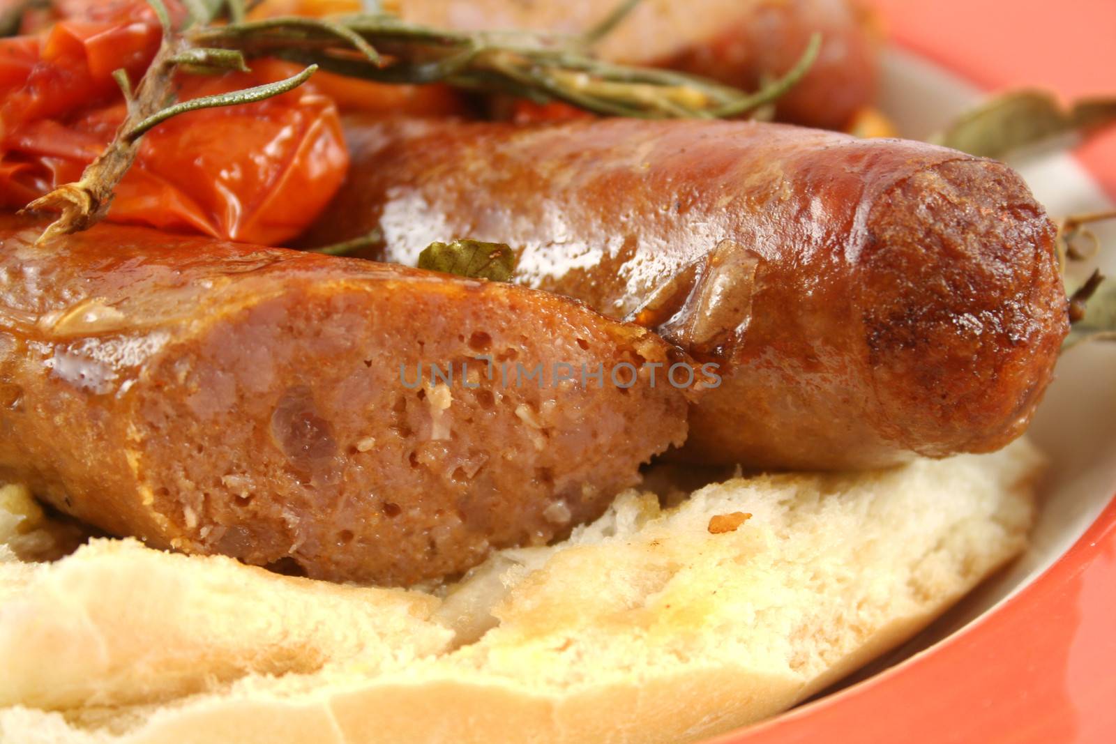 Delicious beef sausages and cherry tomato bake with rosemary.