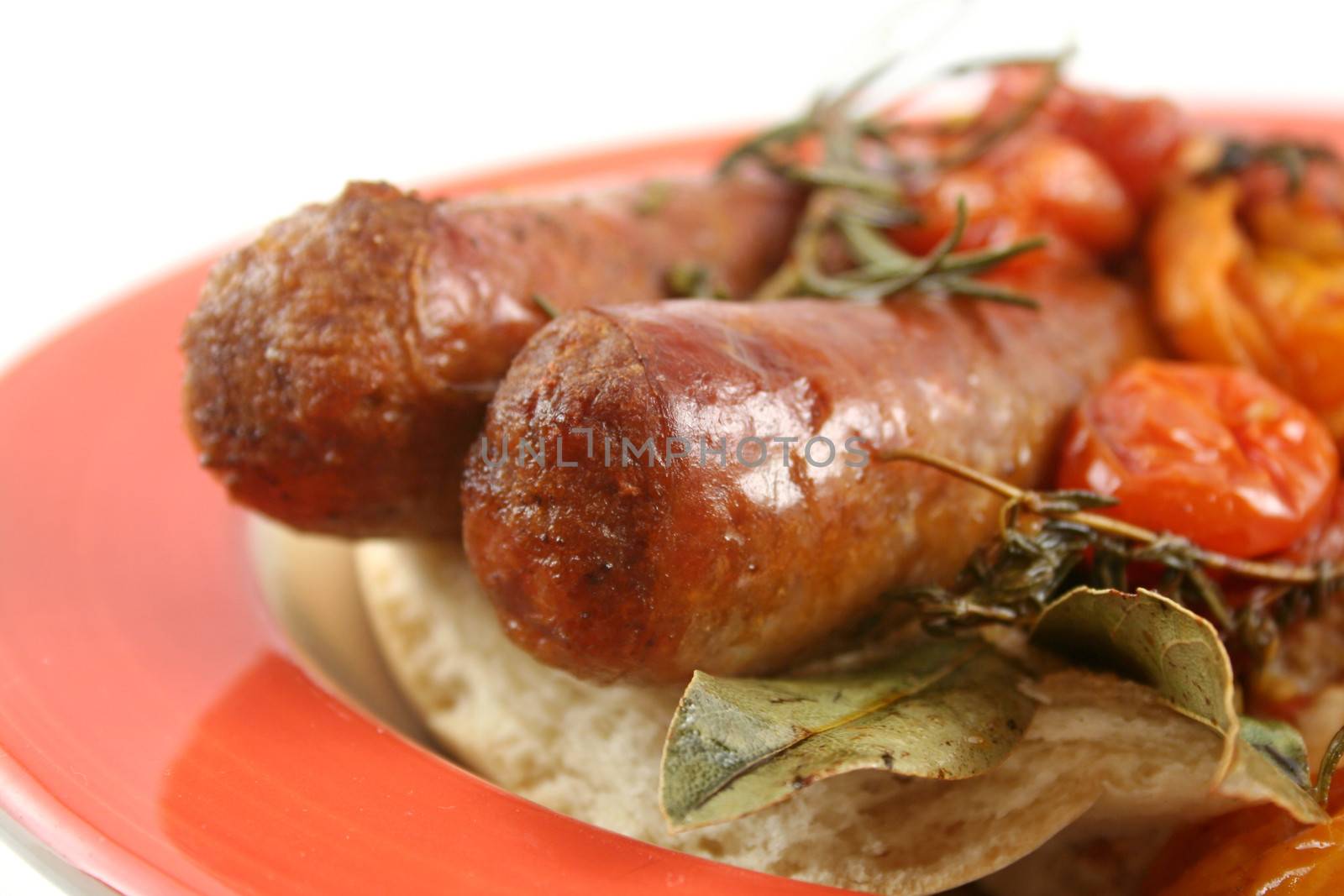 Delicious beef sausage and cherry tomato bake with rosemary.