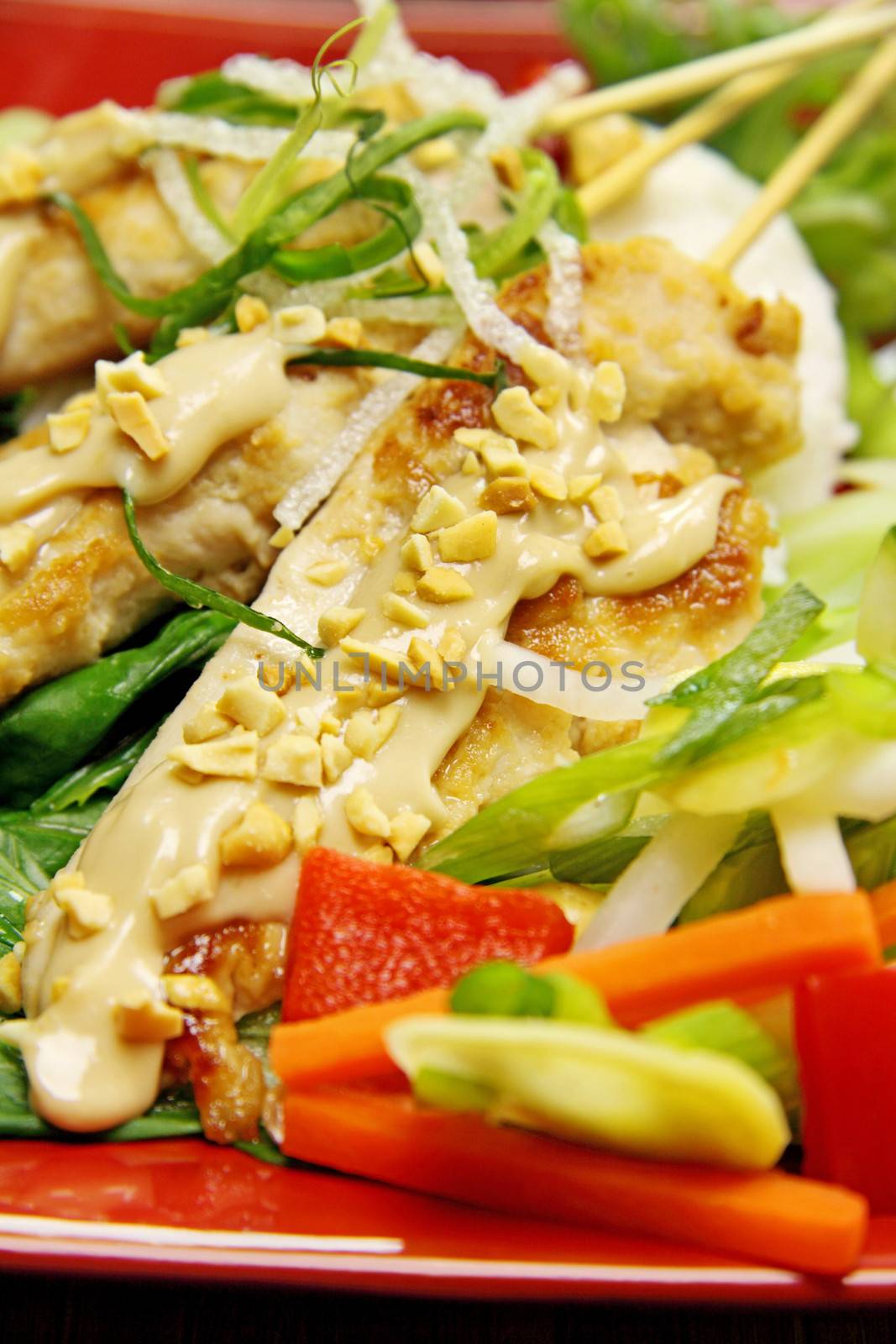 Delicious chicken satay skewers with peanut sauce.