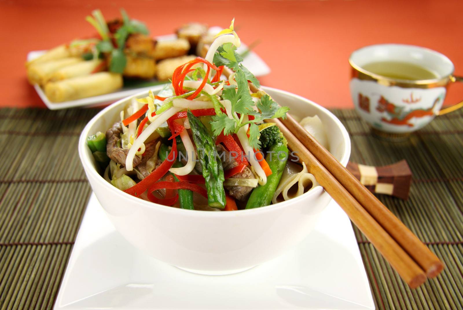 Freshly prepared beef noodle stirfry with dimsums ready to serve.