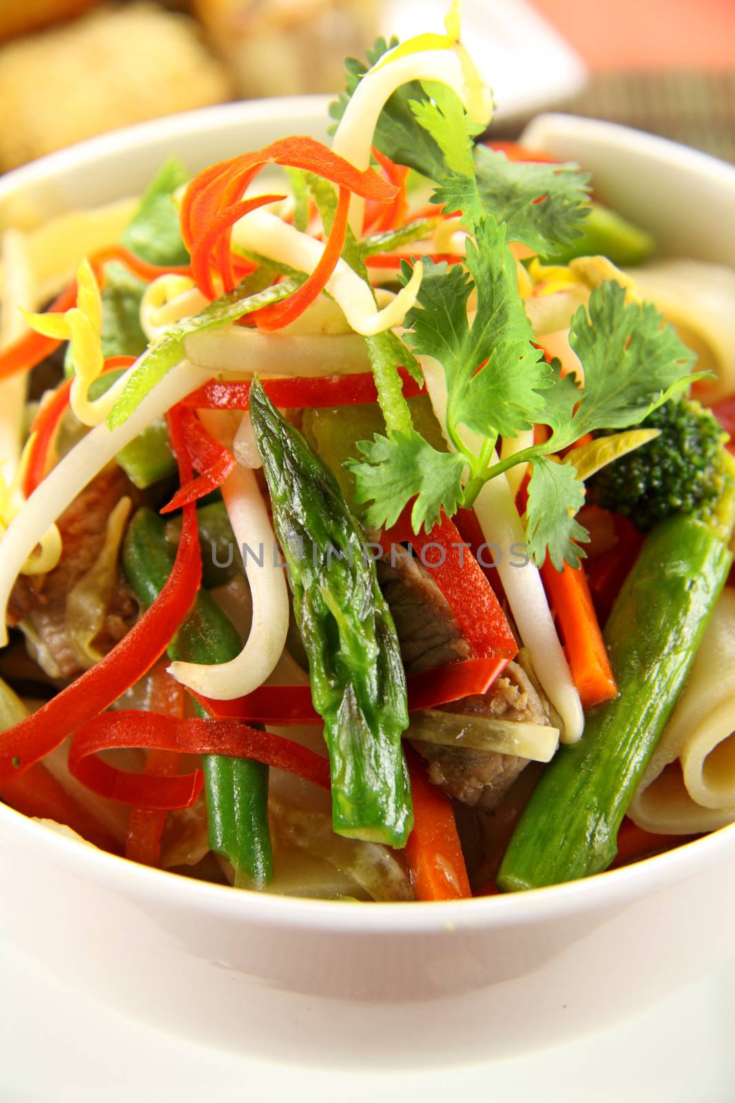 Freshly prepared beef noodle stirfry with dimsums ready to serve.