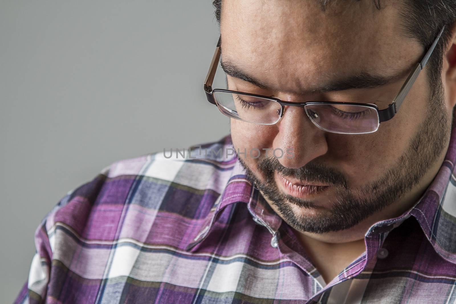 portrait of an overweight man looking down